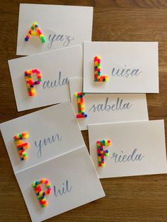 four cards with different colored beads on them