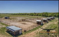 an aerial view of a farm with horses in the fenced area and cows on the other side