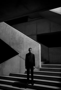 a man in a suit standing on some steps