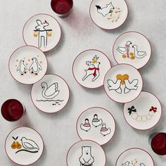 a table topped with lots of white and red plates