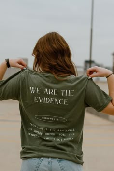 "WE ARE THE EVIDENCE Based on Hebrews 11:1, this shirt was designed to unpack the reality of who our trust is in. Even though we can't physically see the Father, we know and believe in Him by faith. He has placed us all in unique situations to be a physical representation of a heavenly reality. We are meant to show this reality of the Father to people who don't know Him. We are made for the Father to work through us to reveal Himself to the world. We are the evidence.  \"Now faith is the convict Dc Clothing, Christian Gift Shop, Hebrews 11 1, Jesus Clothes, Christian Shirts Designs, Hebrews 11, Christian Streetwear, Church Shirt, Christian T Shirts