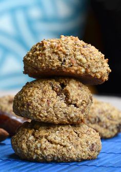 three cookies stacked on top of each other next to a wooden spoon and some nuts