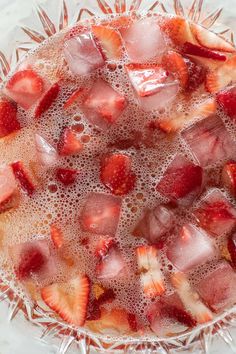 strawberries and ice in a bowl with water