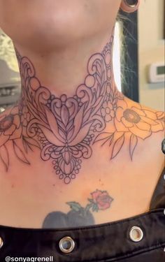 a woman with tattoos on her neck and chest