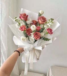 a person holding a bouquet of flowers in their hand