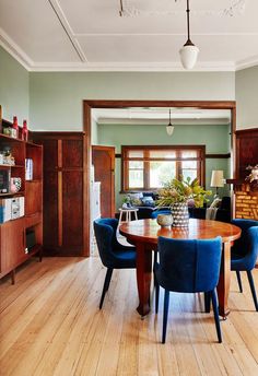 a dining room table with blue chairs around it