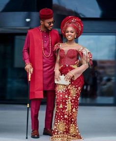 a man and woman dressed in red standing next to each other