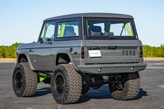 an off - road vehicle is parked in a parking lot