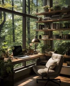 a chair sitting in front of a window next to a laptop computer