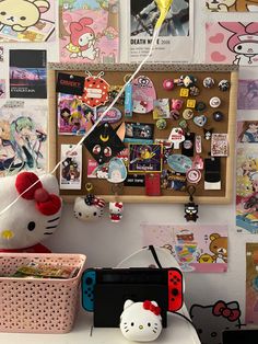 there is a hello kitty sticker on the wall next to a nintendo wii game controller