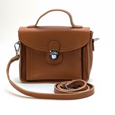 The Isabelle is an elegant and versatile satchel bag designed to complement your everyday style. Materials: Handcrafted from durable, high-quality leather. Functional Interior: Offers a well-organized interior with enough space for your essentials, including a phone, wallet, keys, and small personal items. The secure flap with a lock closure ensures your belongings are safe and easily accessible. Versatile Carrying Options: The adjustable shoulder strap allows for comfortable cross-body wear, wh Functional Interior, Chic Accessories, Satchel Bag, Phone Wallet, Everyday Style, High Quality Leather, Satchel Bags, Classic Looks, Cross Body Handbags