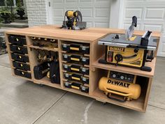 a workbench with tools in it on the driveway