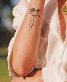 a woman with a flower tattoo on her arm