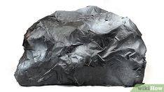 a rock that is covered in tin foil on a white background with clippings