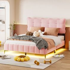 a bed with pink headboard and pillows on top of it, surrounded by other furniture