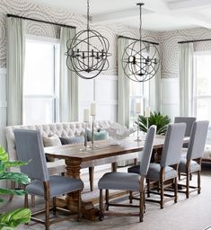 the dining room table is surrounded by chairs and chandeliers with numbers on them