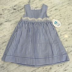 This Is A Brand New Luli And Me Girls Dress. Beautiful Blue With White Stripe. There Is A Crinoline Layer To Help The Dress Look Full. It's A Pretty Scallop Lace Detail Around The Waist With Red Accent. The Dress Buttons Up The Back. This Is A Very Beautiful Classic Dress. I Also Have A Little Bubble That Matches This Sweet Dress. All Of My Items Are New From My Closed Children's Shop. I Am Pricing At Cost, Please Do Not Send Silly Offers Cute Blue Lined Dress, Blue Spring Dresses For Playwear, Spring Blue Dresses For Playwear, Blue Dresses For Playwear In Spring, Blue Dresses For Spring Playwear, Blue Sleeveless Playwear Dresses, Cotton Gingham Dress With Lace Trim, Blue Scalloped Lace Summer Dress, Blue Lace Mini Dress With Scalloped Detail