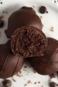 three chocolate candies on a plate with one cut in half