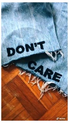 two pieces of clothing with the words don't care written on them and torn in half