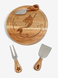 a wooden cutting board with two knives and a spatula