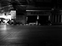 a car parked in front of a building at night