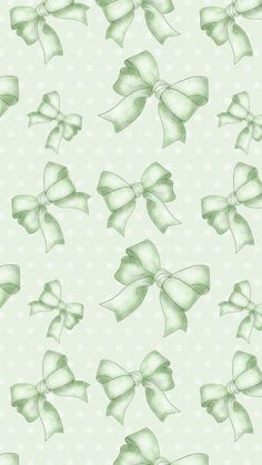 a green and white wallpaper with bows on it's backgroung