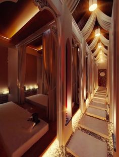 the interior of a luxurious hotel room is lit up with lights and draping