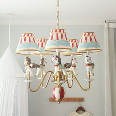 a chandelier hanging from the ceiling in a child's room with toys on it