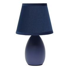 a blue table lamp with a dark blue shade on the base and a white background