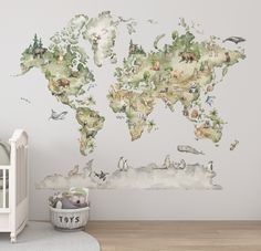 a baby's room with a wall mural that has animals on it