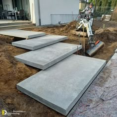 construction workers are working on the side of a building that is being built with concrete