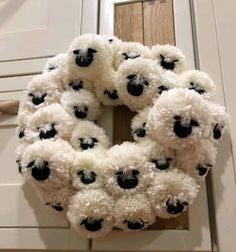 a wreath with black and white sheep on it