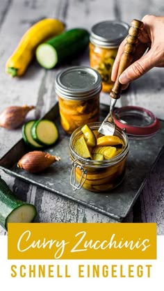 a person spooning pickles into a jar filled with cucumber zucchini