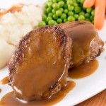 some meat and vegetables on a plate with gravy