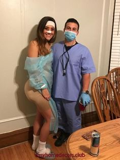 a man and woman in scrubs standing next to each other near a dining room table