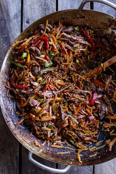 a skillet filled with stir fried noodles and vegetables