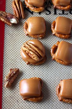 there are many mini sandwiches made to look like pretzels and pecans on the table