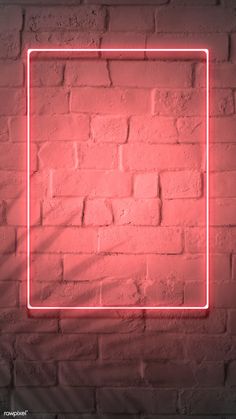 a red neon frame on a brick wall in the shape of a square with a shadow