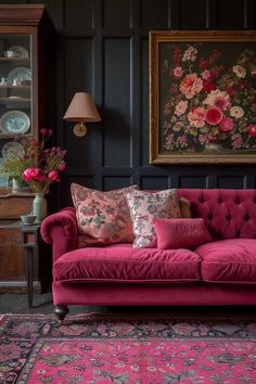 a living room with pink couches and rugs on the floor in front of black walls