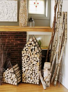 there are many logs stacked next to each other in front of a fireplace mantel