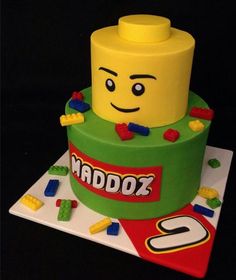 a lego themed cake on a plate with the name naddoz spelled in lego letters