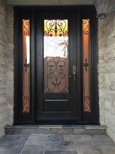 a black front door with glass and wrought iron