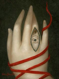 a woman's hand with an evil eye and red string wrapped around her wrist