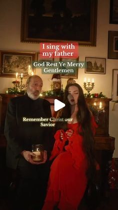 a man and woman standing next to each other in front of a christmas tree with candles