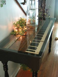 an old piano keyboard has been turned into a table i am in love