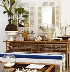 a living room filled with furniture and a large plant on top of a coffee table