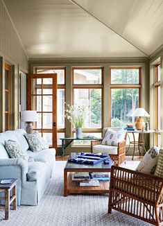 a living room filled with furniture and lots of windows