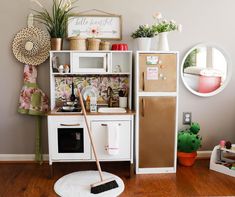 there is a small kitchen with a refrigerator and stove top oven on the floor in front of it