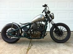 a motorcycle parked in front of a garage door