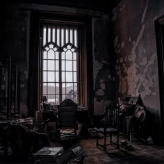 a dark room with an open window and lots of furniture